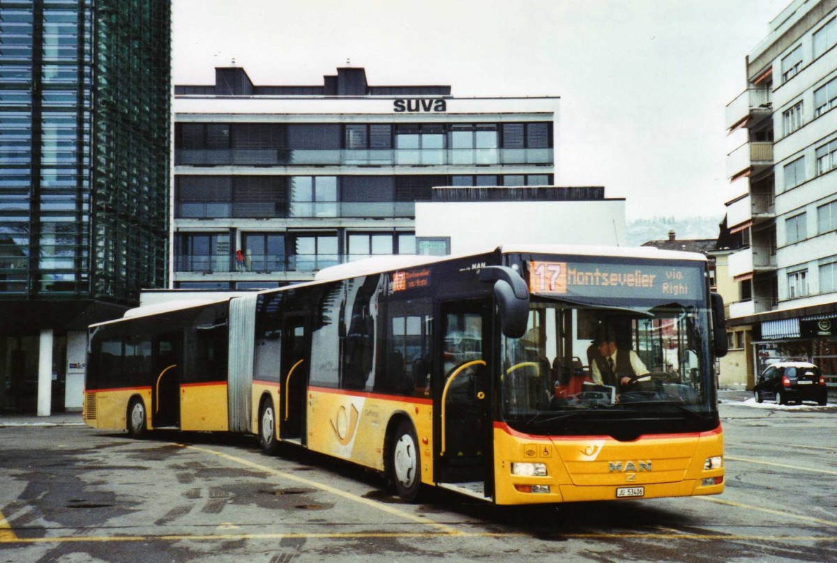 (124'424) - CarPostal Ouest - Nr. 36/JU 53'406 - MAN am 15. Februar 2010 beim Bahnhof Delmont