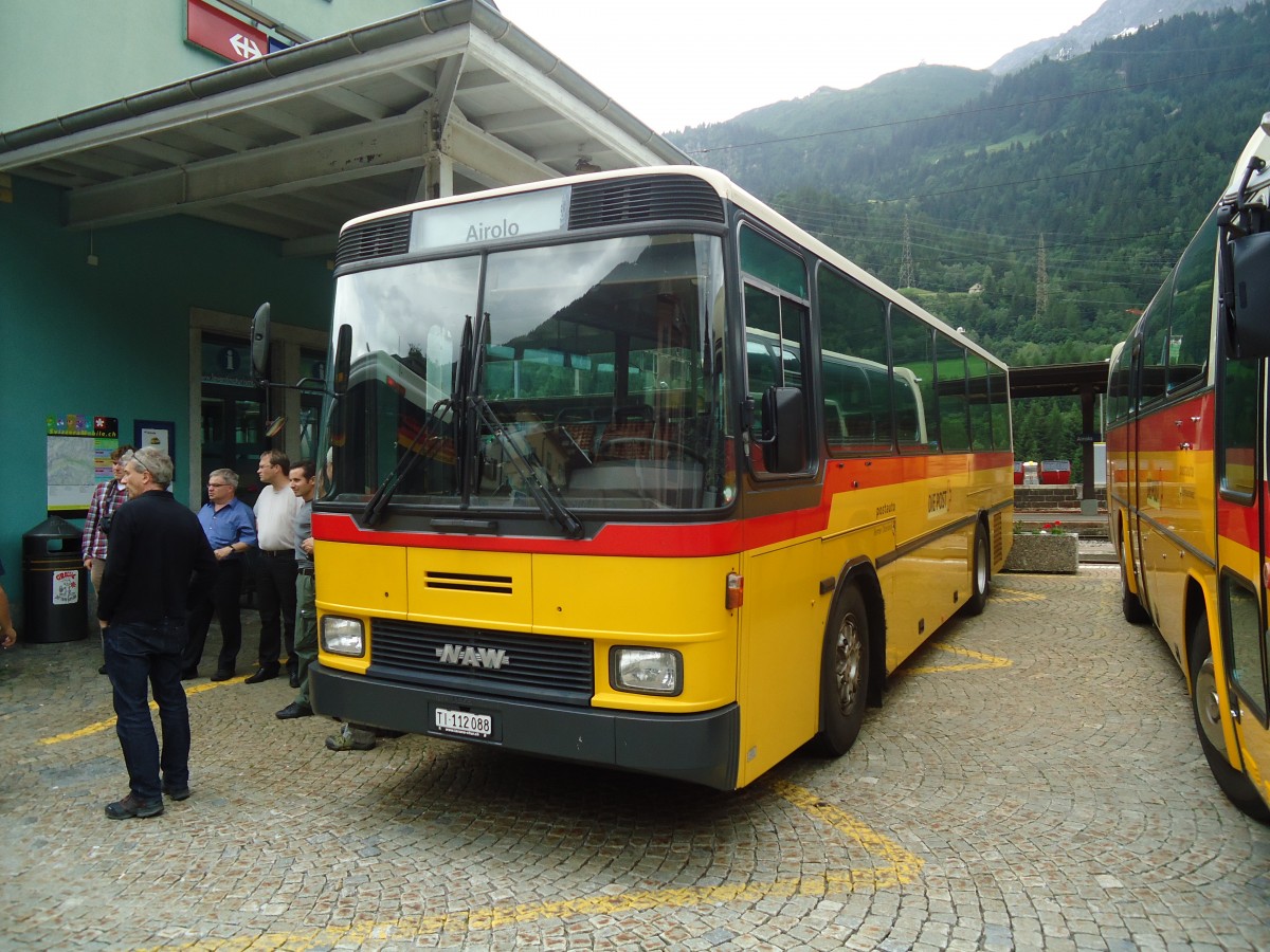 (140'348) - Marchetti, Airolo - TI 112'088 - NAW/Hess (ex PostAuto Bern; ex AVG Meiringen Nr. 66; ex P 24'452) am 1. Juli 2012 beim Bahnhof Airolo