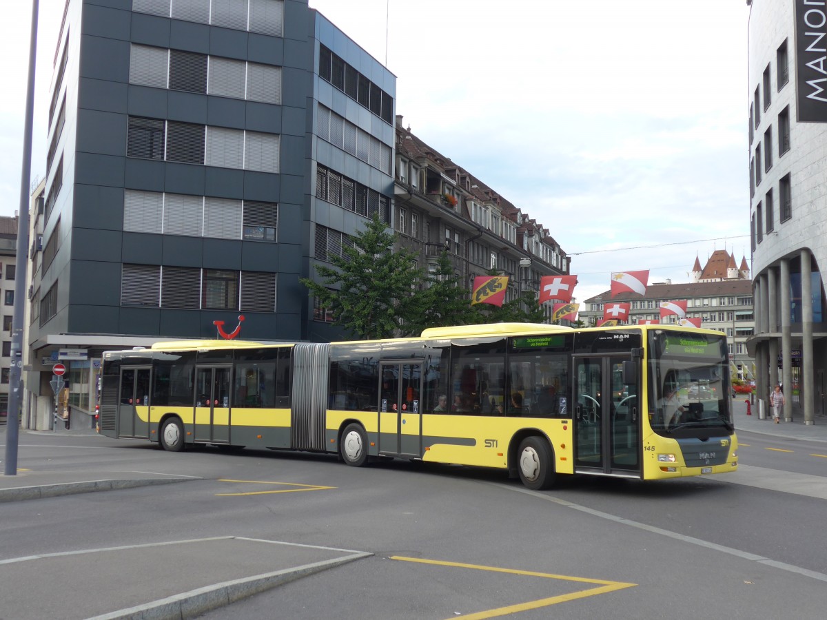 (155'311) - STI Thun - Nr. 145/BE 801'145 - MAN am 20. September 2014 beim Bahnhof Thun