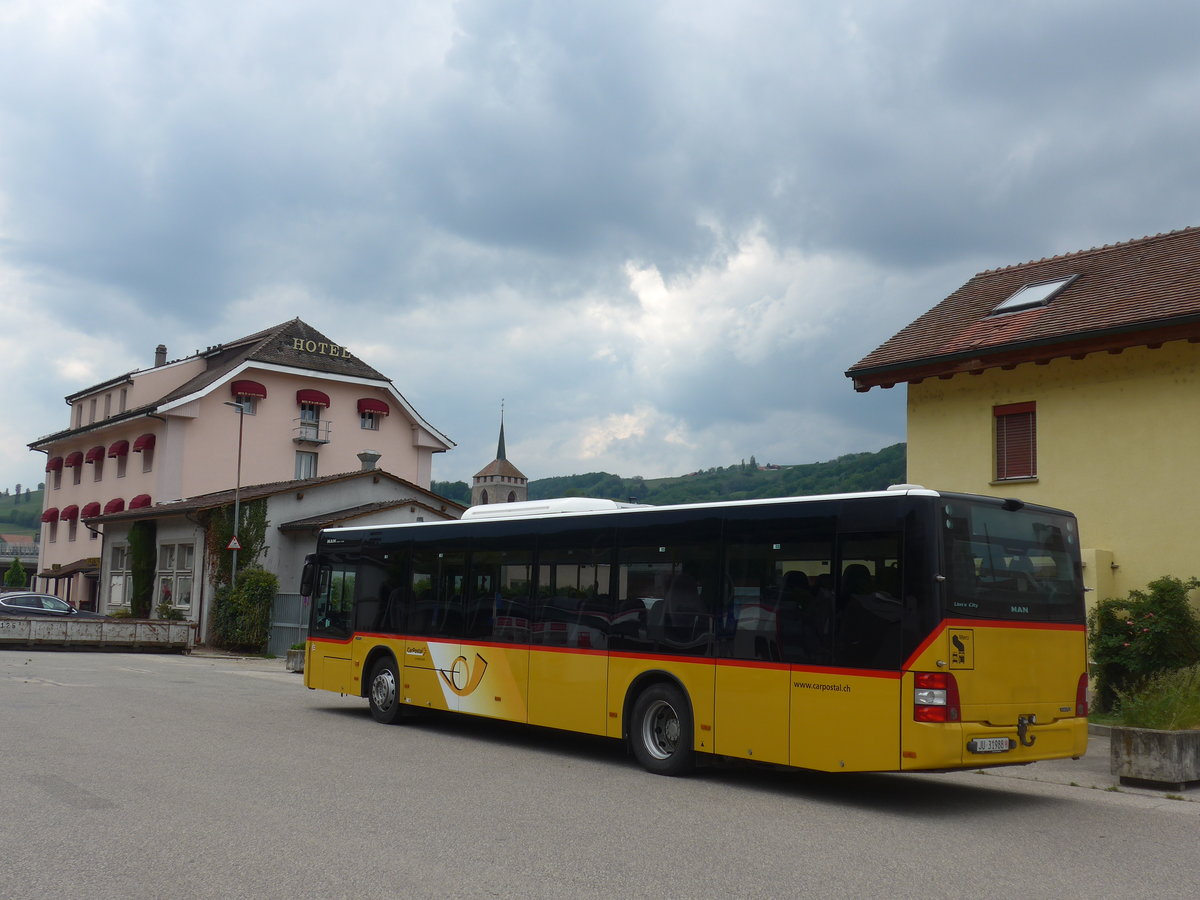 (205'448) - CarPostal Ouest - JU 31'988 - MAN am 25. Mai 2019 beim Bahnhof Moudon