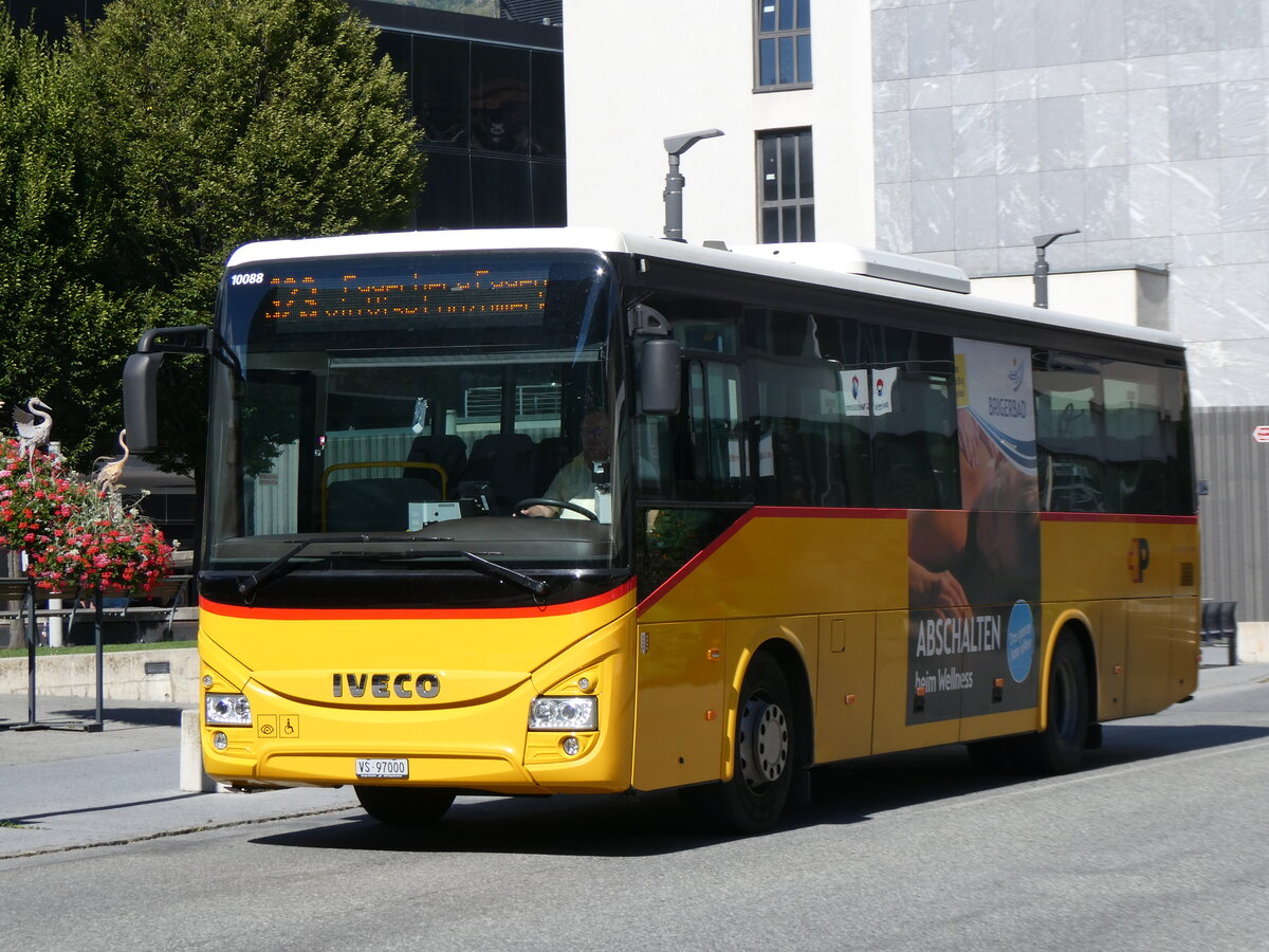 (265'214) - BUS-trans, Visp - VS 97'000/PID 10'088 - Iveco am 28. Juli 2024 beim Bahnhof Visp